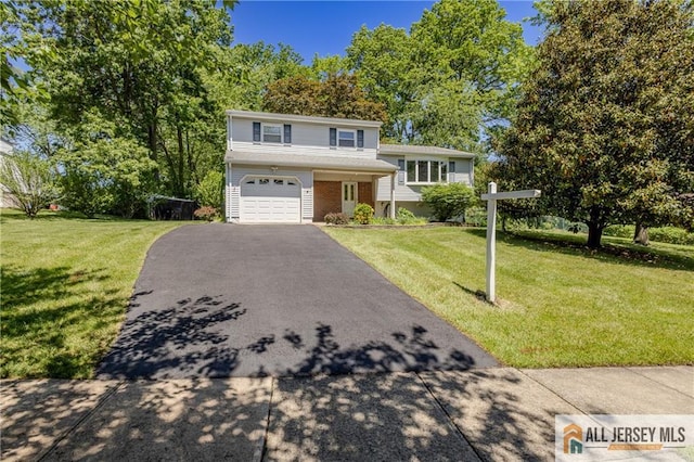 3 Revock Rd, East Brunswick, NJ 08816 - tri-level home featuring a garage, driveway, a front yard, and brick siding