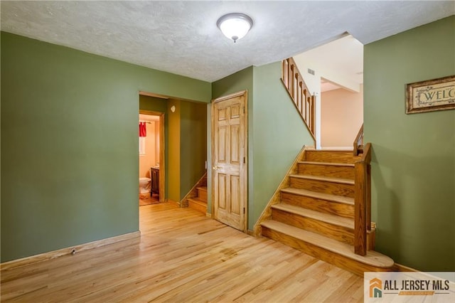 3 Revock Rd, East Brunswick, NJ 08816 - stairs featuring wood finished floors and a textured ceiling