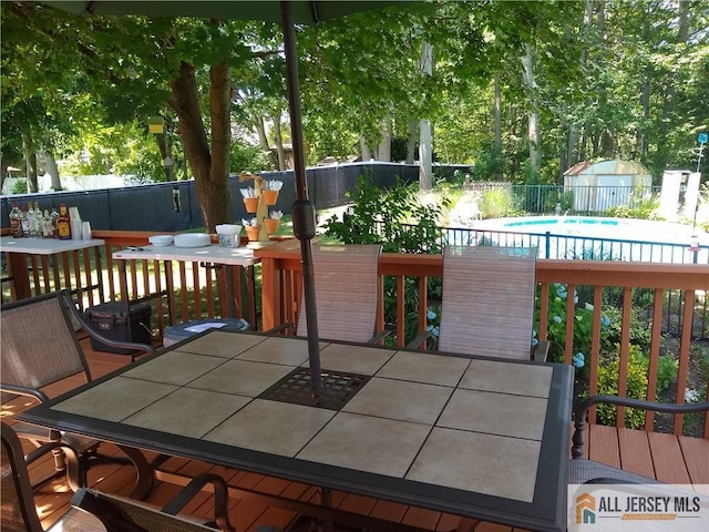 3 Revock Rd, East Brunswick, NJ 08816 - wooden terrace with outdoor dining area and a fenced backyard