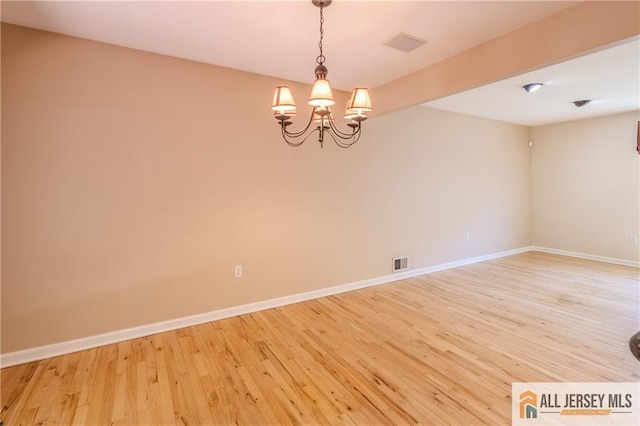 3 Revock Rd, East Brunswick, NJ 08816 - unfurnished room featuring light wood-style floors, a chandelier, and baseboards