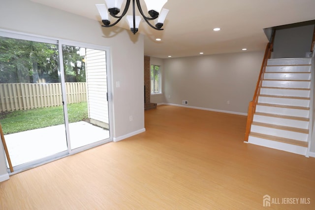 117 Nathan Dr, North Brunswick, NJ 08902 - unfurnished room with wood finished floors, stairway, a chandelier, and recessed lighting