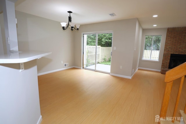 117 Nathan Dr, North Brunswick, NJ 08902 - unfurnished living room featuring wood finished floors, healthy amount of natural light, a chandelier, and recessed lighting