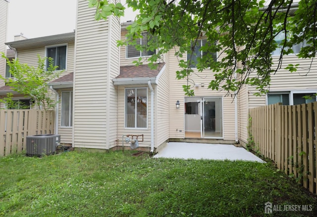 117 Nathan Dr, North Brunswick, NJ 08902 - back of property with a fenced backyard, a patio, and a chimney