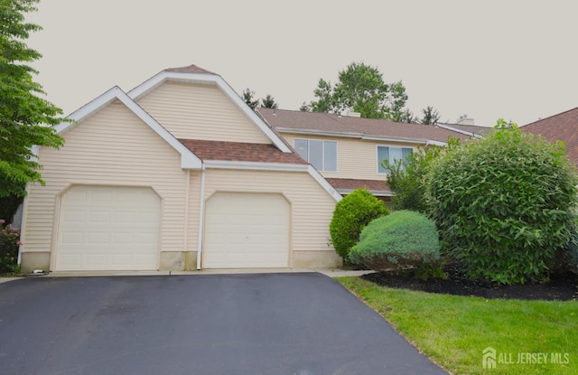 117 Nathan Dr, North Brunswick, NJ 08902 - view of front of house featuring driveway, a shingled roof, and a garage