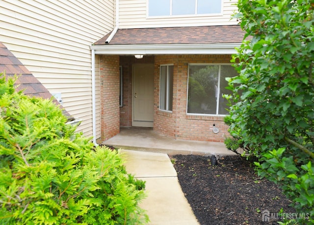 117 Nathan Dr, North Brunswick, NJ 08902 - entrance to property with brick siding and a shingled roof