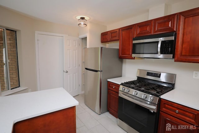 117 Nathan Dr, North Brunswick, NJ 08902 - kitchen with stainless steel appliances, dark brown cabinets, light countertops, and light tile patterned floors