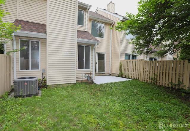 117 Nathan Dr, North Brunswick, NJ 08902 - back of house featuring a fenced backyard and roof with shingles