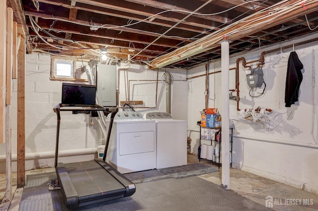 basement with washing machine and clothes dryer and electric panel