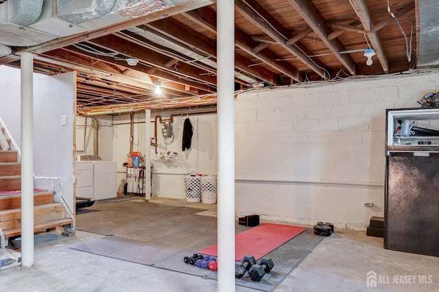 unfinished basement featuring washer and dryer and stairway
