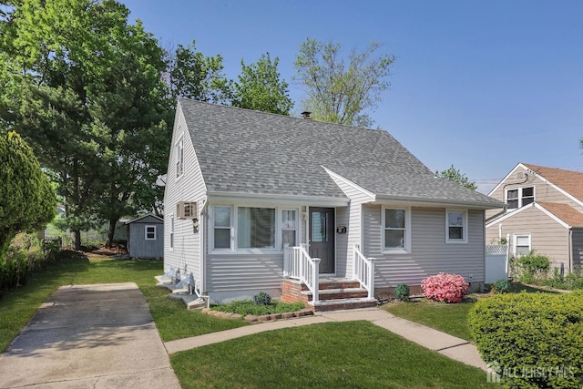 view of front of home with a shingled roof, cooling unit, a chimney, and a front yard
