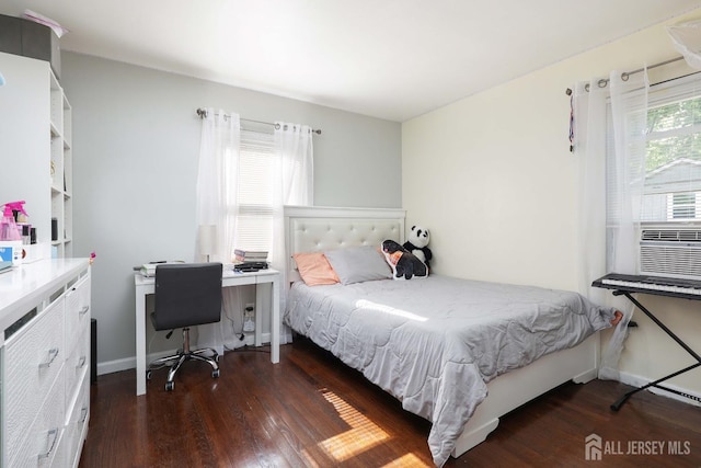 bedroom featuring baseboards, cooling unit, and wood finished floors