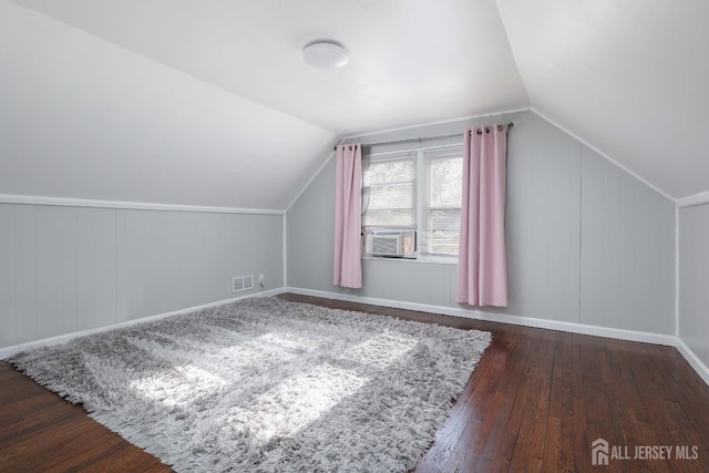 bonus room featuring cooling unit, lofted ceiling, baseboards, and hardwood / wood-style floors