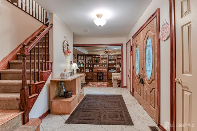 tiled foyer entrance with ceiling fan