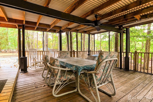 sunroom featuring beamed ceiling and ceiling fan