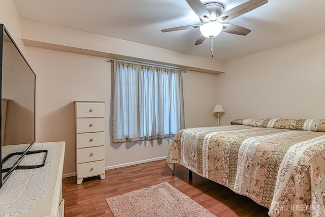 bedroom with hardwood / wood-style flooring and ceiling fan