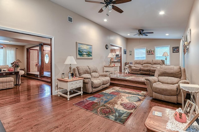 living room featuring vaulted ceiling, ceiling fan, and dark hardwood / wood-style flooring