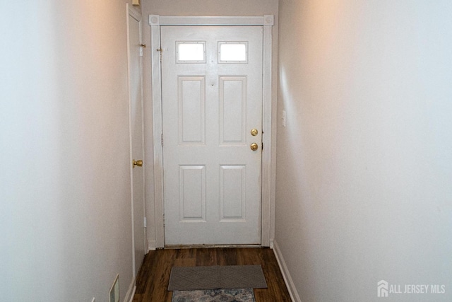 doorway to outside with baseboards and dark wood-style flooring