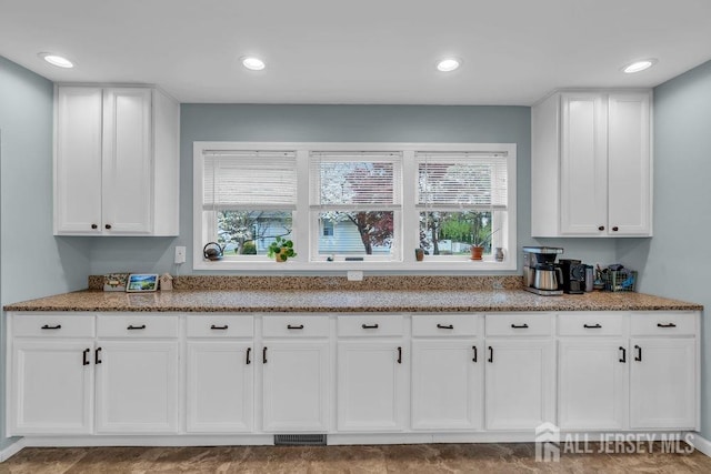 82 Hauser Ave, Hamilton, NJ 08620 - kitchen featuring healthy amount of natural light, light stone counters, white cabinets, and recessed lighting