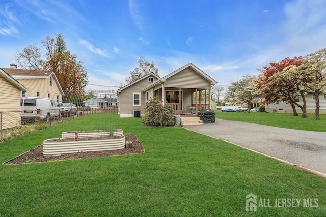82 Hauser Ave, Hamilton, NJ 08620 - back of property featuring covered porch and a vegetable garden