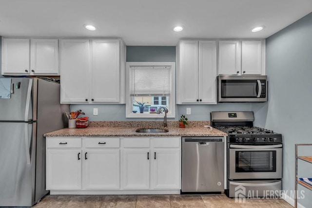 82 Hauser Ave, Hamilton, NJ 08620 - kitchen with stainless steel appliances, white cabinets, light stone countertops, and recessed lighting