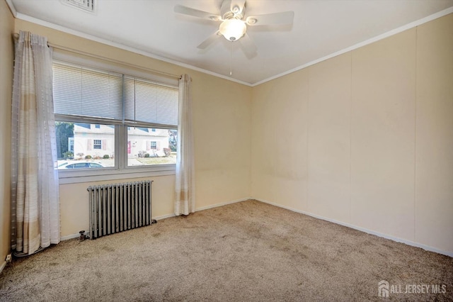 carpeted empty room with radiator, ceiling fan, and ornamental molding