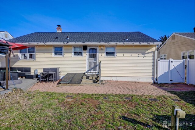 back of house with a lawn and a patio area