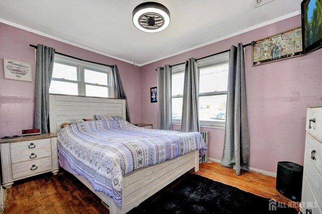 bedroom featuring dark wood-type flooring and ornamental molding