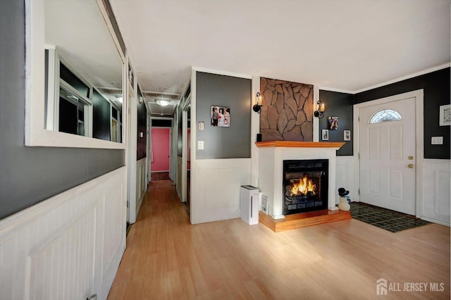 entrance foyer with light hardwood / wood-style floors and ornamental molding