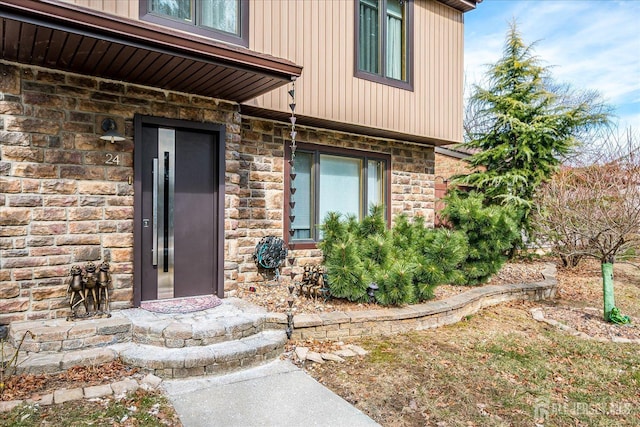 entrance to property with stone siding and elevator