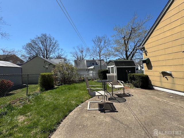 view of yard with a patio area, a storage shed, and an outbuilding