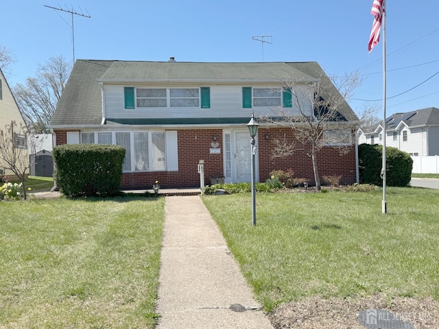 bungalow-style house featuring brick siding and a front yard