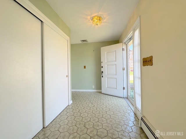 foyer featuring a baseboard radiator and baseboards