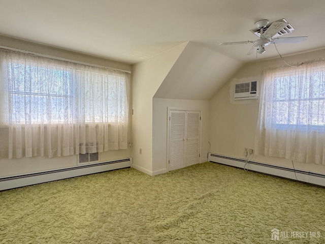 additional living space featuring healthy amount of natural light, carpet flooring, a ceiling fan, vaulted ceiling, and baseboard heating
