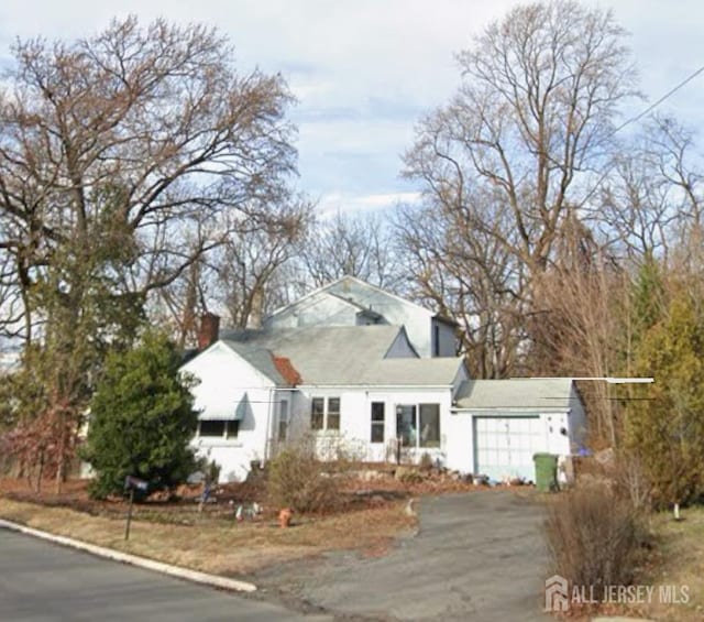 bungalow-style house with driveway and an attached garage