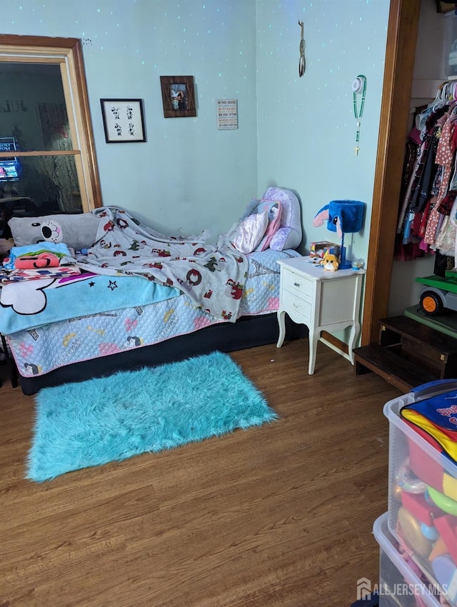 bedroom featuring dark wood-style flooring