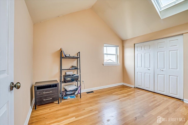 121-F Beverly Hill Ter, Woodbridge Proper, NJ 07095 - unfurnished bedroom featuring a skylight, lofted ceiling, wood finished floors, and a closet