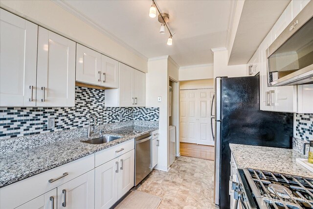 121-F Beverly Hill Ter, Woodbridge Proper, NJ 07095 - kitchen with stainless steel appliances, white cabinets, crown molding, backsplash, and light stone counters
