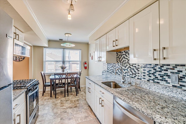 121-F Beverly Hill Ter, Woodbridge Proper, NJ 07095 - kitchen featuring appliances with stainless steel finishes, ornamental molding, tasteful backsplash, white cabinets, and light stone countertops