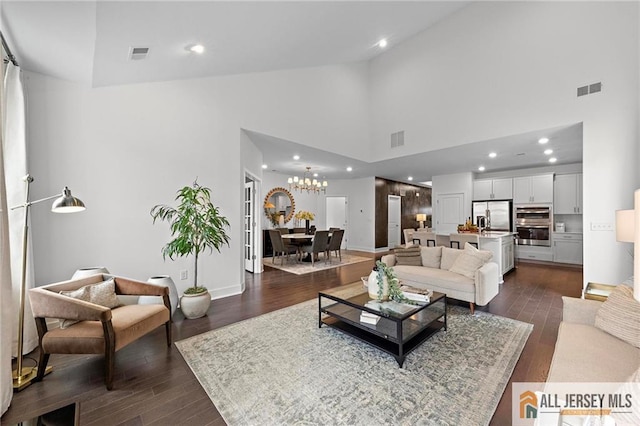 15 Galerie Ct, Monroe, NJ 08831 - living room with high vaulted ceiling, dark wood-type flooring, a chandelier, and recessed lighting