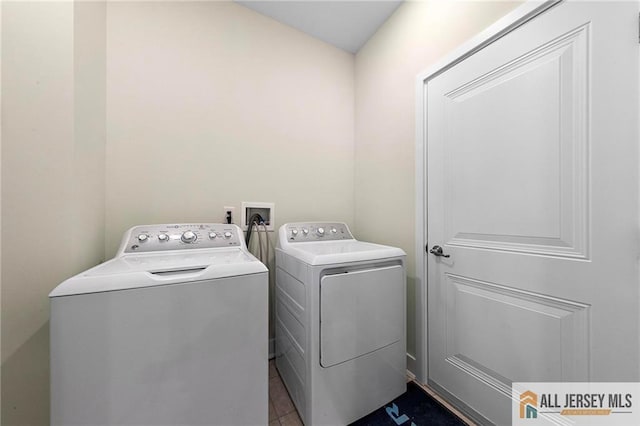 15 Galerie Ct, Monroe, NJ 08831 - laundry room with washer and clothes dryer and dark tile patterned flooring