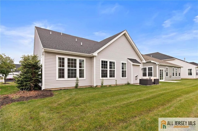 15 Galerie Ct, Monroe, NJ 08831 - back of house with a lawn, an outdoor living space, and a shingled roof