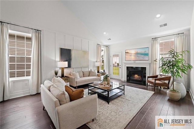 15 Galerie Ct, Monroe, NJ 08831 - living area with a decorative wall, dark wood-type flooring, a fireplace with flush hearth, high vaulted ceiling, and recessed lighting