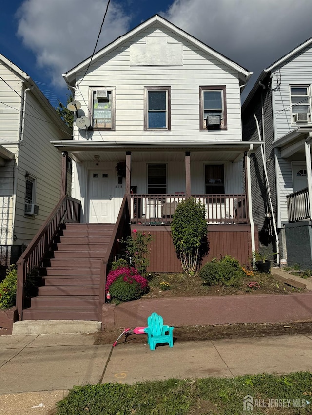 view of front facade featuring a porch and cooling unit