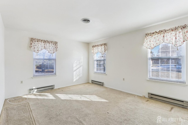 empty room featuring carpet and a baseboard radiator