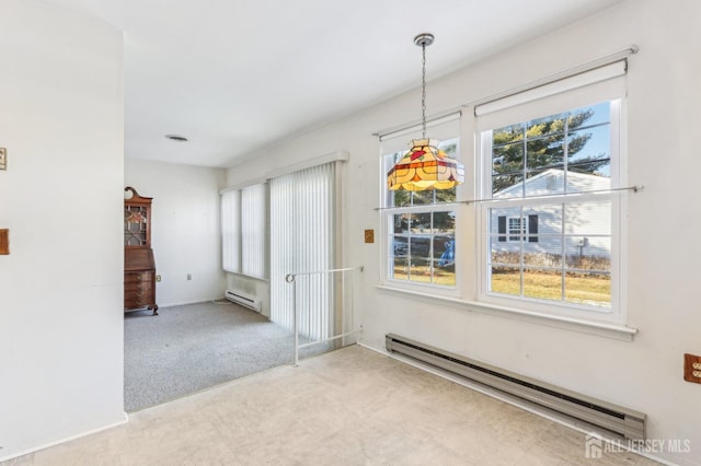 unfurnished dining area with a baseboard radiator, light colored carpet, and plenty of natural light