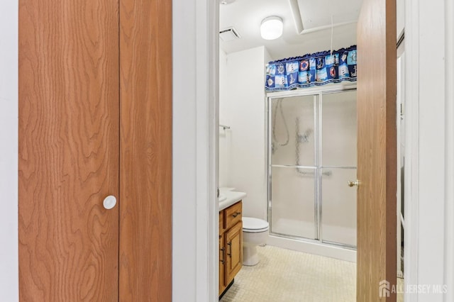 bathroom featuring toilet, tile patterned flooring, vanity, and walk in shower