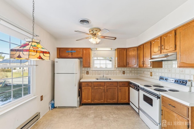 kitchen with sink, white appliances, a baseboard heating unit, and backsplash