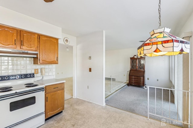 kitchen featuring electric range, decorative light fixtures, and decorative backsplash