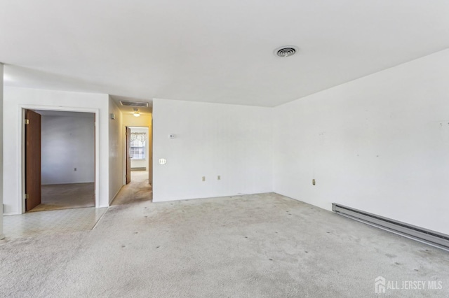 carpeted spare room with baseboard heating