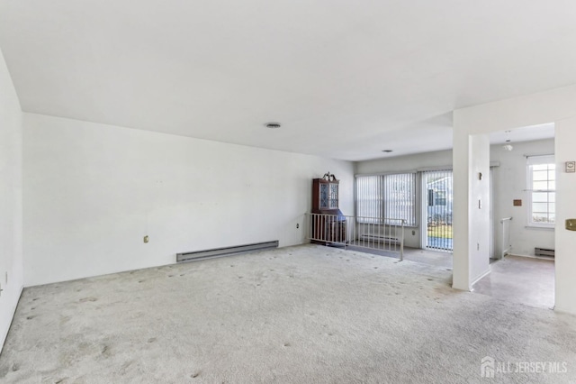 empty room with a baseboard radiator and light colored carpet